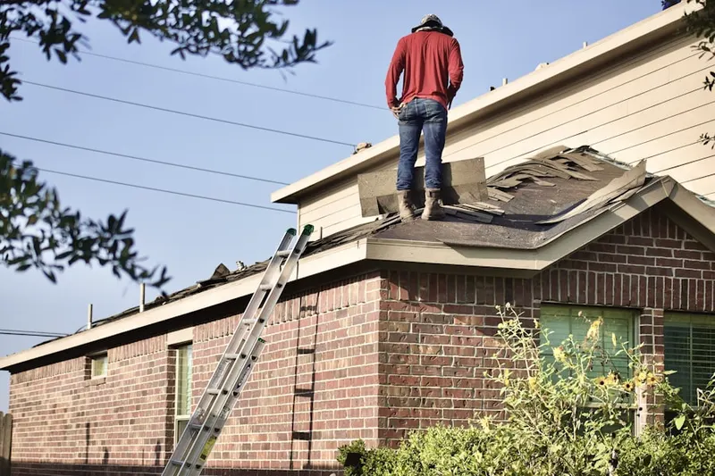 Professional roofer working on a residential roof in West Central